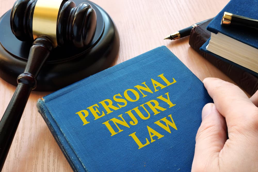 The image of the personal injury law concept with a gavel on a professional office desk. 