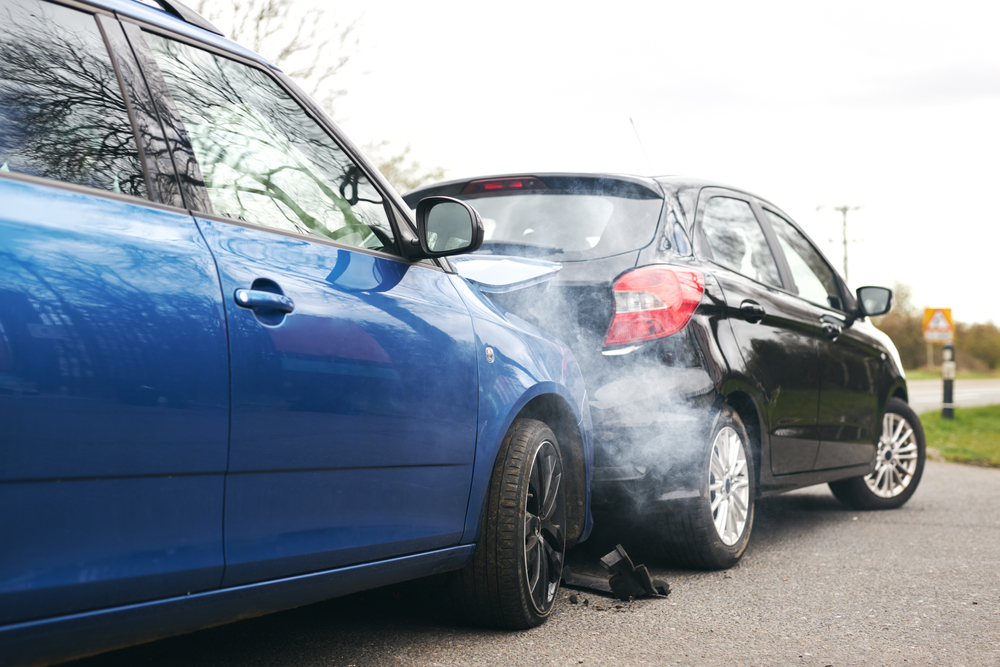 Diagram of a rear-end car accident, depicting vehicle positions and common causes like tailgating and sudden stops.